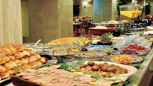A buffet with various food items including salmon, bread, and fruits. - Matsue Universalhotel   (Matsue)