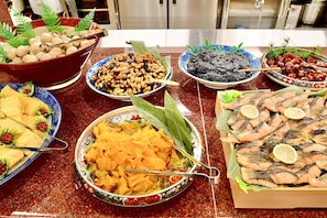 Fresh ingredients and seasonal dishes are carefully arranged on the kitchen counter.