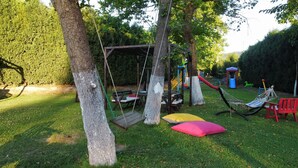 A playground with swings, a hammock, and a slide. - SAPANCA RESORT HOTEL (Sapanca)