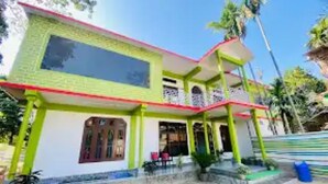 A two-story building with a balcony on the upper floor. - Kaziranga Inn (Bokakhat)