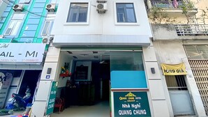 A multi-story building with a storefront at the ground level. - Quang Chung Hotel Long Bien- Bay Luxury (Hanoi)