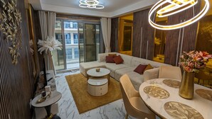 Luxury Apartment, 2 Bedrooms, Beach View, Beachfront | Living area | 40-inch Smart TV with digital channels - UAEVACAY (Ras Al Khaimah)