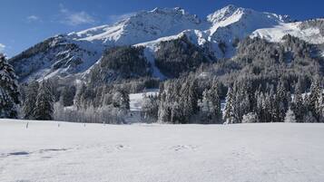 A snow-covered mountain landscape with a clear sky.