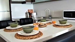A modern kitchen with a central island, a microwave, and a sink. - Phaedrus Living: Seaview Luxury Flat Lighthouse 53 (Paphos)