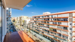 A multi-story residential building with balconies and a clear view of the street below. - A&N Los Angeles (Torre del Mar)