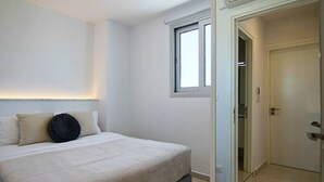 A bedroom with a bed, a window, and a door leading to another room. - Phaedrus Living Seaside Executive Flat Harbour 203 (Paphos)
