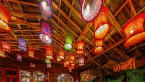 A rustic interior with wooden beams and hanging lanterns. - Sapaxa Spring Garden Ecolodge (Ta Phin)