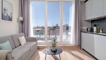 One-Bedroom Apartment with terrace | Living area | 43-inch flat-screen TV with cable channels