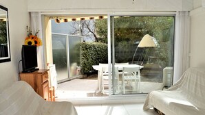 A bedroom with a bed, a TV, a desk, and a chair.