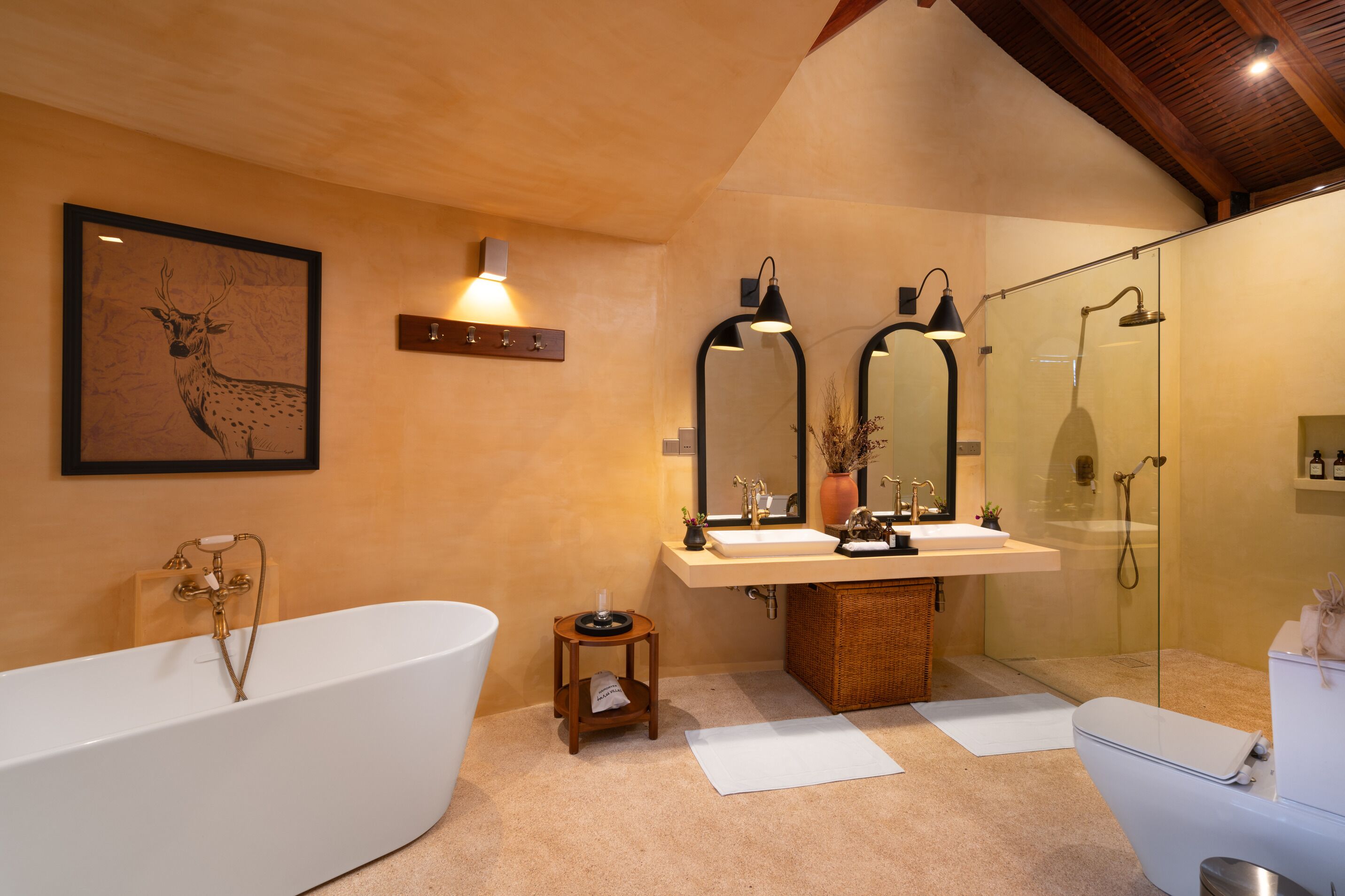 A modern bathroom with a freestanding bathtub, a double sink vanity, and a glass-enclosed shower area.