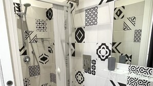 A modern bathroom with a shower, toilet, and sink. - Domus Giordano (Rome)