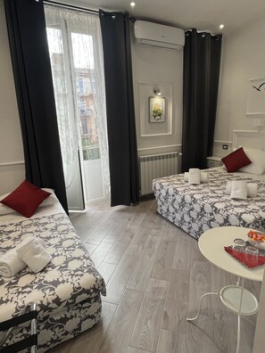 Une chambre d’hôtel avec deux lits, une table à manger et une vue sur la ville.