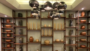 A room with a sofa, shelves with pottery, and hanging pendant lights. - Lofts Marques Oaxaca (Oaxaca)