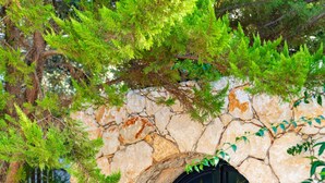 A stone wall with a black door featuring star and crescent patterns. - Villa Olivia is on the corner of one of the prettiest streets in Kalkan (kas)