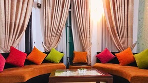 A living room with two sofas, colorful cushions, and a coffee table. - Ared Villa (Seeduwa - Katunayake)