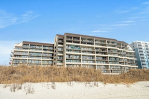 A multi-story hotel with a flat roof and numerous balconies.