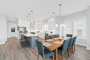 Enjoy cooking in this well-lit kitchen with a central island, ample counter space, and refrigerator.