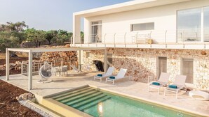 A modern two-story house with a stone facade, a rooftop terrace, and a swimming pool. - My Rental Homes - Villa Panita with swimming pool private garden wifi (Ostuni)