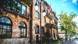 A historic building with arched windows, a stone facade, and a tiled roof. - ApartaSuite Spa Work Bogota  (Bogotá)