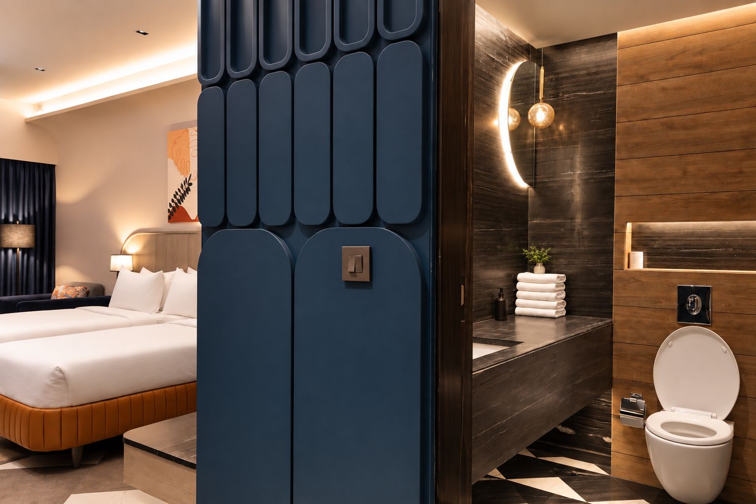 A modern hotel room with a large bed, a bathroom with a toilet and sink, and a decorative wall panel.