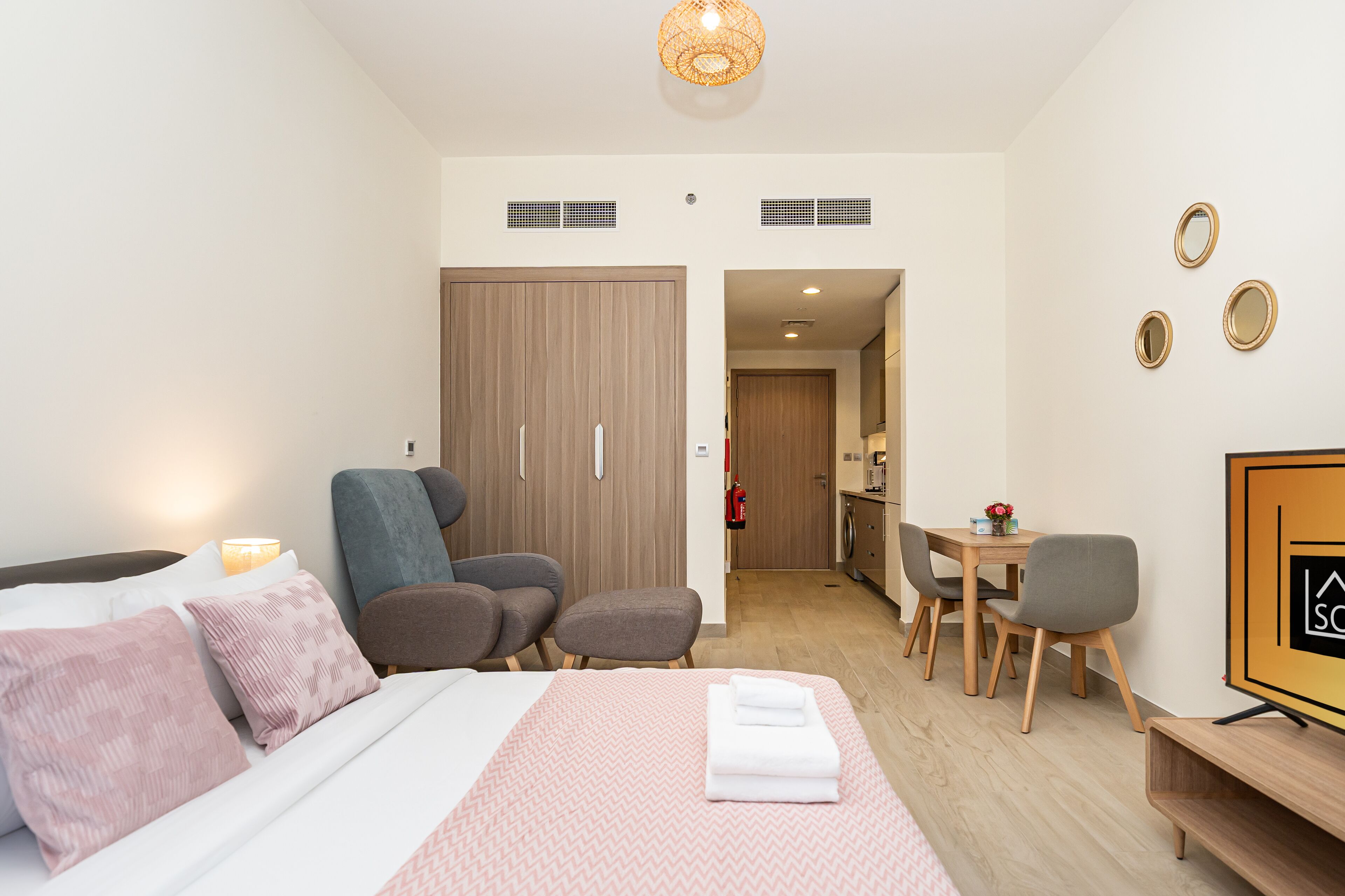 Ein modernes Hotelzimmer mit Bett, Sitzecke und Esstisch.
