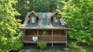 A log cabin with a porch, two dormer windows, and a sign that reads 'Camp You.' - Cabin for 4 • Hot Tub • Jetted Tub • Arcade Loft (Sevierville)