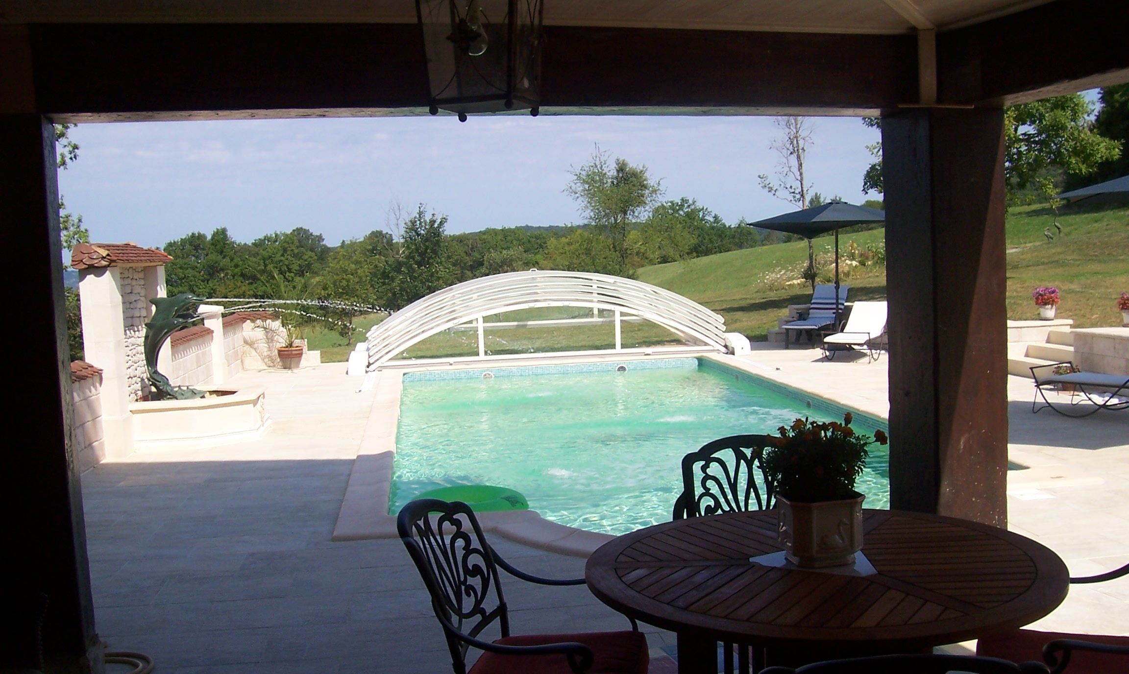 A covered patio with a pool, outdoor furniture, and a date stamp.