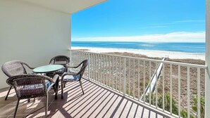 A balcony with wicker furniture and a view of the beach. - Tidewater 505 - Orange Beach on the Beach - 1bd/1bath - Sleeps 6 (Orange Beach)