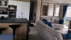 A compact living space with a kitchenette, a sofa, and a dining area.