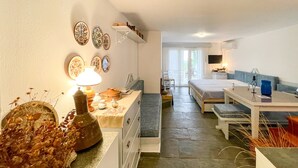Quarto de hotel compacto com cozinha compacta, área de refeições e uma pequena varanda.