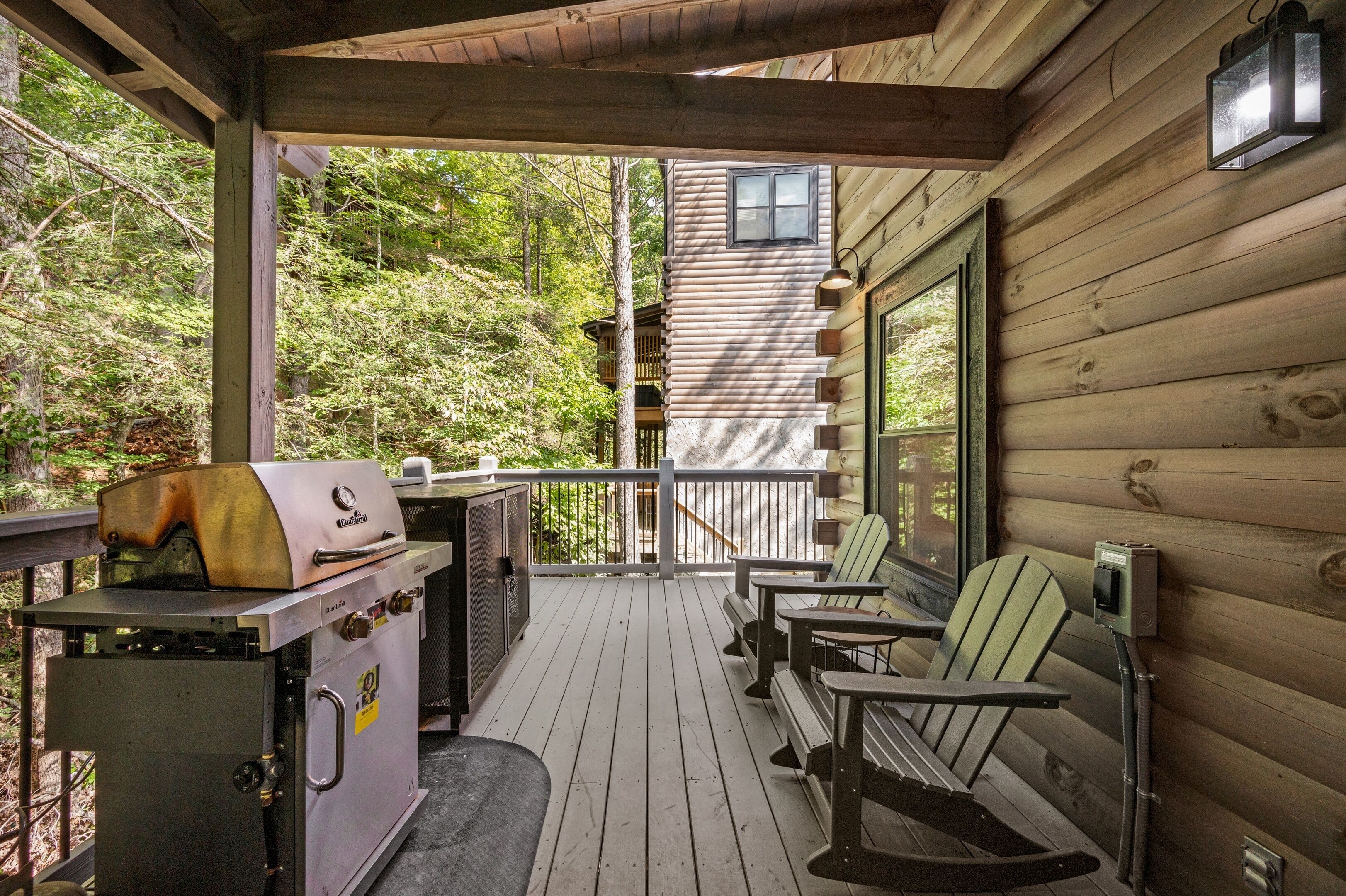 A wooden deck with a grill and outdoor seating.