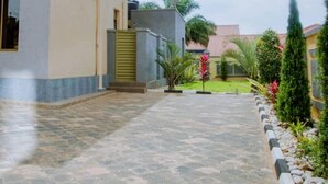 Un edificio con un sendero pavimentado que conduce a una entrada con puerta.