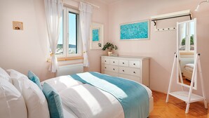 A bedroom with a bed, a dresser, a mirror, and a window with curtains. - Sun Spalato Hills 8 (Split)