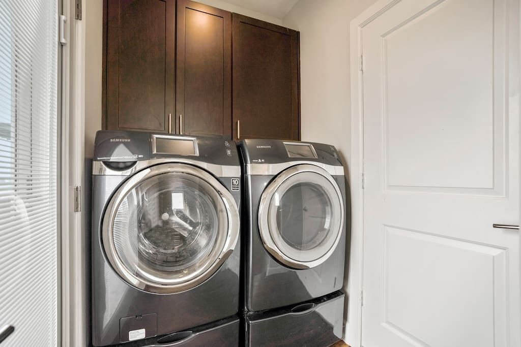 A laundry room with two stacked front-loading washing machines.