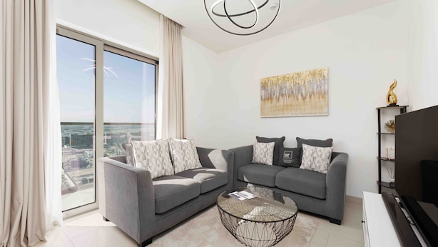 A modern living room with two grey sofas, a glass coffee table, and a large window offering a city view. - Maison Privee - Modern & Chic Retreat 10min from Downtown Dubai (Dubai)