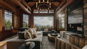 A spacious living room with a large sectional sofa, a fireplace, and a view of the mountains. - Unique Ridge Top Location by InvitedHome | Gondola, Hot Tub, O2, Ski-In/Out (Telluride)