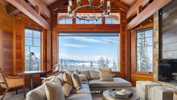 A cozy living room with a large window, a fireplace, and a wooden ceiling. - Unique Ridge Top Location by InvitedHome | Gondola, Hot Tub, O2, Ski-In/Out (Telluride)