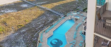 A resort with a swimming pool, beach access, and a view of the ocean.