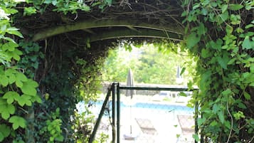 Seasonal outdoor pool, open 10:00 AM to 8:00 PM, pool umbrellas