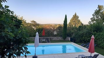 Seasonal outdoor pool, open 10:00 AM to 8:00 PM, pool umbrellas