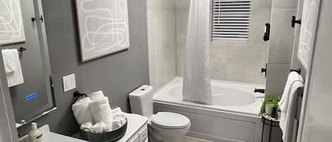 Jetted tub, eco-friendly toiletries, hair dryer, towels