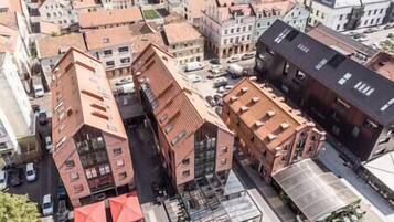 A multi-story building with a central courtyard, surrounded by other buildings.