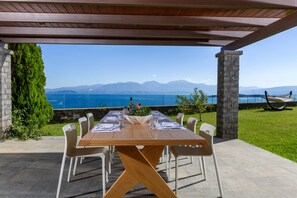 Enjoy al fresco dining with a scenic view of mountains and water from this outdoor dining area.