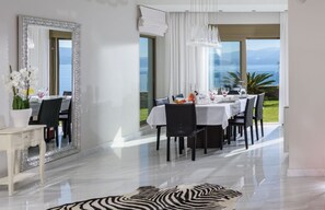 Enjoy meals in a stylish dining area with a large mirror, elegant table setting, and scenic views.