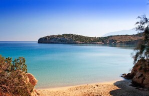 Enjoy a serene coastal escape with a clear sea and sandy beach.