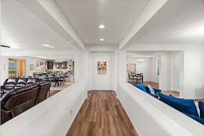 Grand hallway leading to the kitchen, main living room and games room