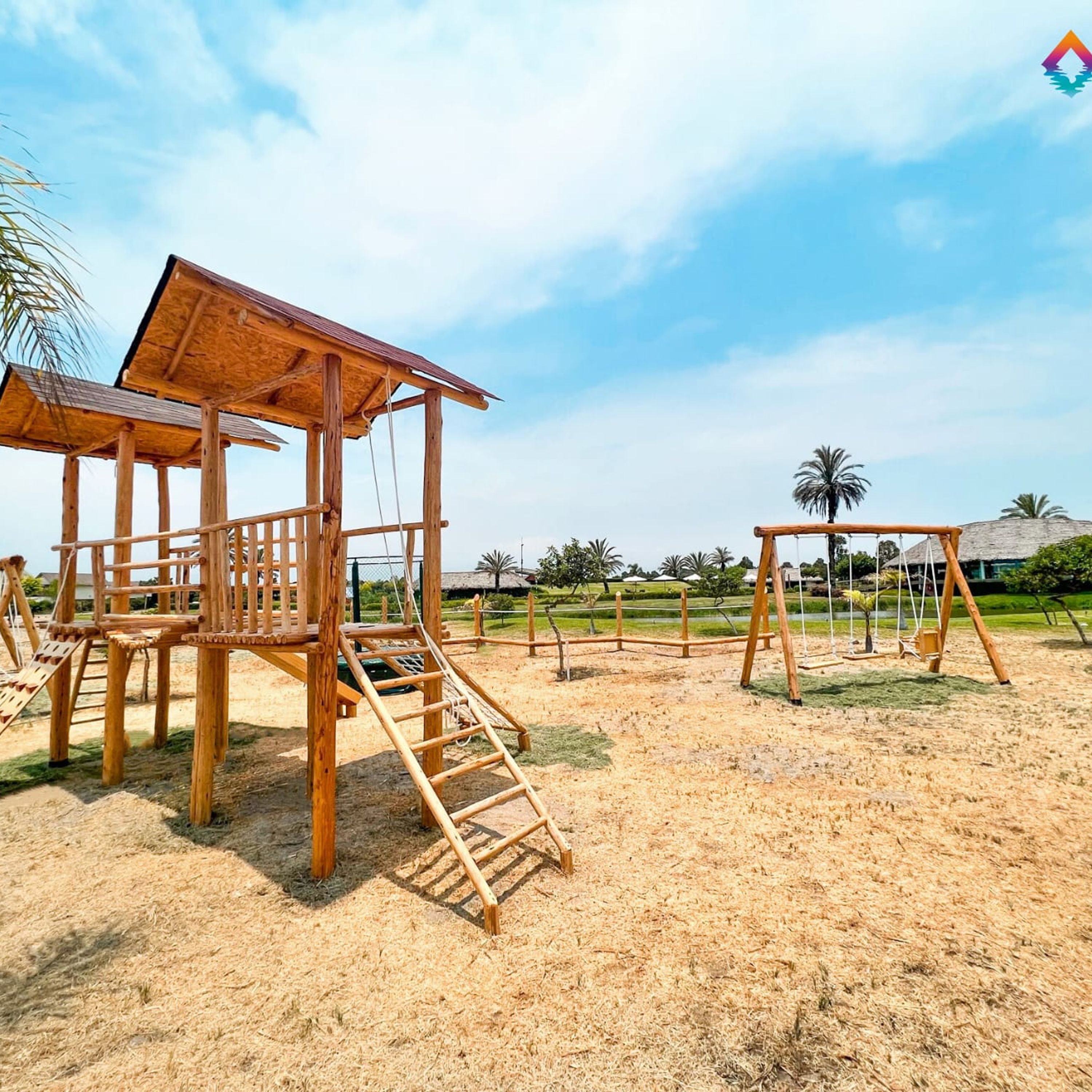 A wooden play structure with a climbing ladder and a covered seating area.
