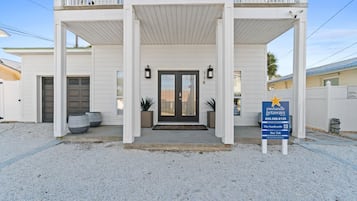 A two-story building with a covered entrance, a dark front door, and a sign for Panhandle Getaways.