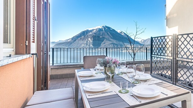 A table set for dining with a mountain view in the background. - Sunny Varenna Apartment (Perledo)
