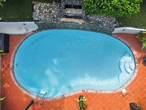 A swimming pool with a tiled edge, surrounded by a brick patio and a stone border. - Massive 3 bedroom with Pool (Palmas del Mar)